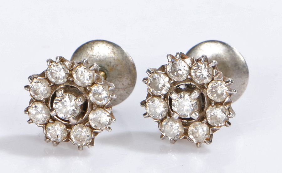 Indian white metal diamond set earrings, the studs set with nine diamonds forming flower heads, 12mm