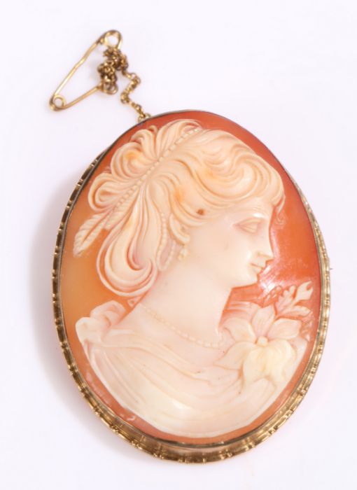 9 carat gold cameo brooch depicting a lady in a floral dress, 5cm long