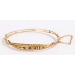 Victorian 9 carat gold sapphire and pearl set bracelet, the head of the bracelet set with a row of