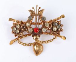 19th Century brooch, with a harp set with paste stone flanked by flower heads and twisted bars, 52mm