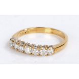 18 carat gold diamond set ring, with a row of seven round cut diamonds at 0.50 carats in total, 2.