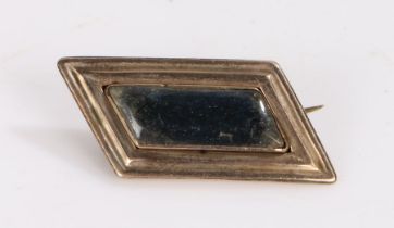 19th Century brooch, the yellow metal angled frame with a central glazed locket panel, 32mm wide