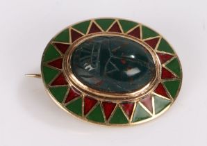 Egyptian revival brooch, the agate scarab beetle set into an oval 14 carat gold enamelled mount,