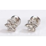 Indian white metal diamond set earrings, each stud set with seven round cut diamonds forming