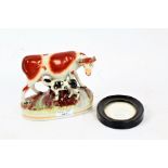 Victorian Staffordshire pottery group, in the form of a cow and calf, 15cm wide, and an ebony and