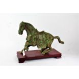 Chinese bronze horse, 20th century, with green patination, raised on wooden plinth, the horse 43cm