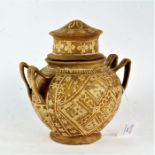 Indian hide vase and cover, of baluster form, with lift up lid and carrying handle either side,