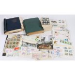 Two World stamp albums, Post Office picture card series postcards depicting stamps, collection of