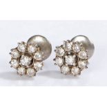 Indian white metal diamond set earrings, the studs set with nine diamonds forming flower heads, 12mm