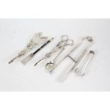 Silver plated wares to include two pairs of grape scissors, cake tongs, sugar tongs, teaspoon,