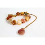 Pink stone necklace together with a bracelet formed out of various stones (2)