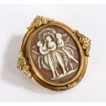 Yellow metal cameo depicting a scene of three classical ladys