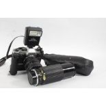 Olympus OM-10 camera body, with a Sunagor f/5.6 75-300mm lens, a Sunpak flashgun, battery pack,