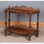 Victorian walnut two tier what-not, the pierced upstand and four turned finials above two shaped