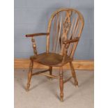 Windsor wheelback elbow chair, the arched back with wheel pierced splat flanked by turned