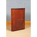 Mahogany veneered hanging corner cupboard, the door enclosing a single shelf, 66cm tall