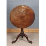 George III mahogany circular tilt top occasional table, the gun barrel stem raised on tripod legs