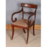 William IV style mahogany elbow chair, with curved cresting rail above a roundel and shell carved