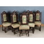 Seven Victorian oak dining chairs, the pierced lion and scroll carved pediments above foliate
