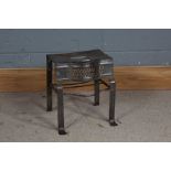 Steel footman, with pierced bow front and side carrying handles, on pad feet, 31cm wide