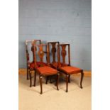 Set of four oak dining chairs, the splats decorated with a carved shell, raised on cabriole legs,