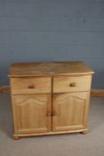 Pine cupboard, with two frieze drawers above two arched panelled cupboard doors, raised on bun feet,