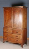 19th century mahogany linen press cupboard, the pair of doors enclosing five sliding trays, the