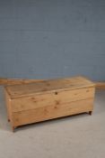 20th century stripped pine coffer, the hinged lid enclosing a candle box interior, 123cm wide, 52.