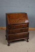 20th century oak bureau on stand, the sloping fall enclosing a fitted interior with two drawers,