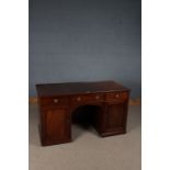 Victorian mahogany desk, with three frieze drawers above an arched kneehole, the pedestals with