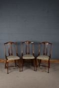 Edwardian mahogany inlaid dining chairs, the shaped pierced splats above upholstered seats, raised