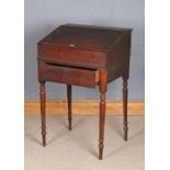 Victorian oak teachers desk, the sloping writing surface opening to reveal a small interior