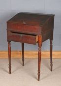 Victorian oak teachers desk, the sloping writing surface opening to reveal a small interior