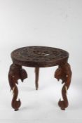 Anglo-Indian carved hardwood occasional table, the circular top caved in relief with a God within