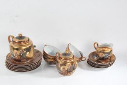 Japanese Satsuma tea ware, all decorated with figures on a gilded ground, comprising teapot, cream