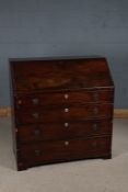 George III mahogany bureau, the sloping fall enclosing a compartmentalised interior, fitted four