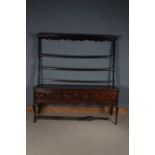 George III oak dresser, the rack with three open shelves above a base with three drawers and wavy