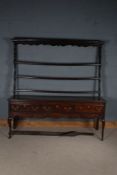 George III oak dresser, the rack with three open shelves above a base with three drawers and wavy