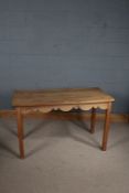 Pine dining table, the rectangular top with rounded corners above a shaped frieze and square legs,