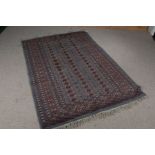 Middle Eastern carpet, the blue ground with elephant foot lozenge pattern centre, multiple borders