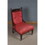 Edwardian mahogany easy chair, the acanthus leaf and scroll carved cresting rail above a button