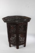 Anglo-Indian carved hardwood folding occasional table, the octagonal top carved in relief with grape