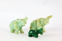 Pair of carved jade elephants, each approx. 9cm wide, and a jade hippopotamus, 5cm (3)