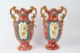 Pair of early 20th Century English pottery vases, the red ground with raised foliate decoration