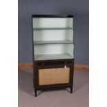 Regency ebonised waterfall bookcase, with three shelves above a frieze drawer and grille fronted