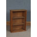 Pine display cabinet, the glazed front revealing two shelves and with rear door, 48cm wide