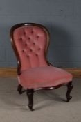 Victorian mahogany spoon back nursing chair, with pink button back upholstery and raised on cabriole