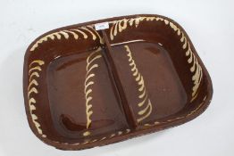 19th Century slipware dish, of rectangular form with central division, the brown ground with cream