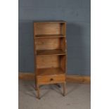 Pine waterfall bookcase, with two shelves and frieze drawer, raised on square legs, and castors,