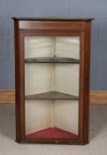 Edwardian mahogany and marquetry inlaid hanging corner cupboard, the glazed door opening to reveal